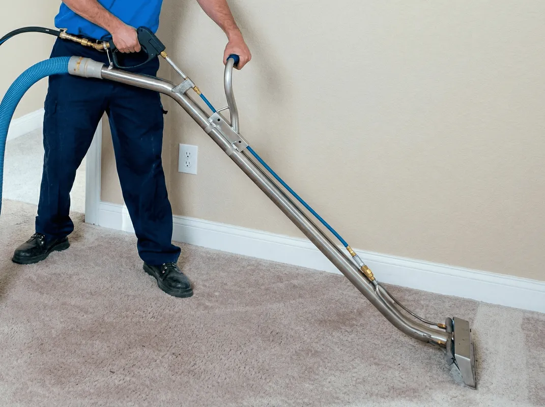 Professional operating a liquid removal machine on a carpeted floor in Gilbert, AZ